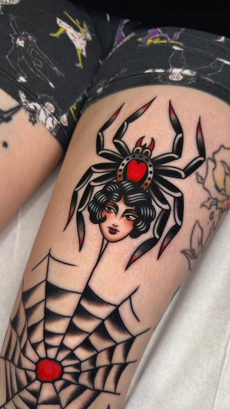 Traditional Lady Tattoo: 9 Designs for Every Style 8 A traditional style tattoo of a spider with a woman's face on a person's leg.