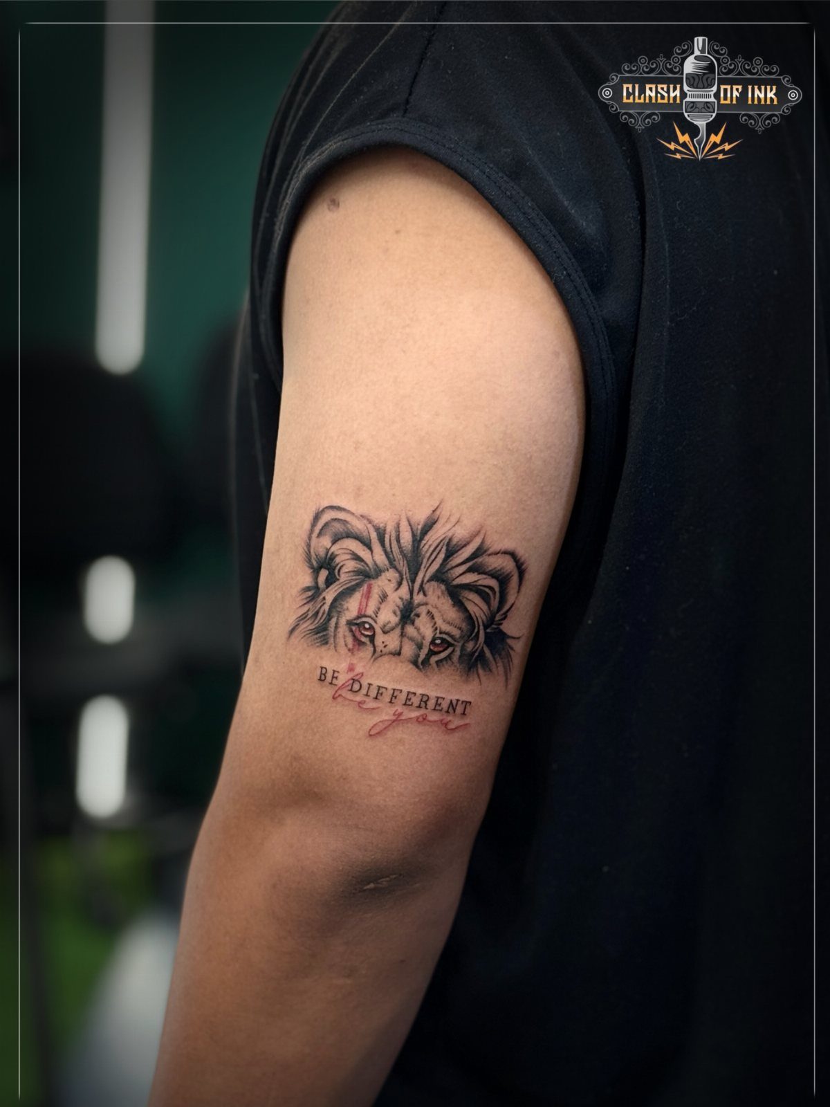 A lion face tattoo with the text be different on a person's upper arm.