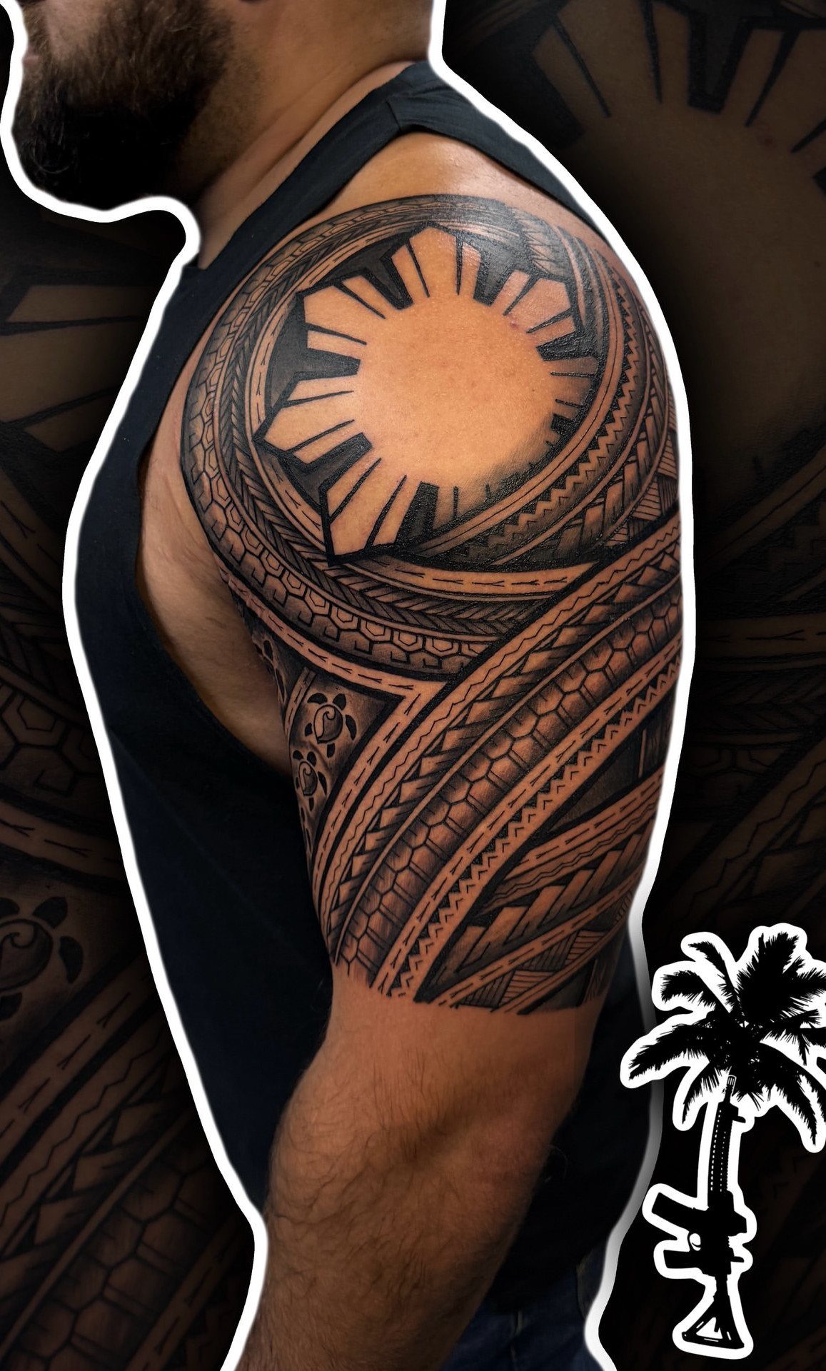 Polynesian Tattoo Pattern: 16 Island Styles From Marquesan to Maori 11 A man's arm displaying a large black Polynesian tattoo featuring a sun motif and geometric patterns.