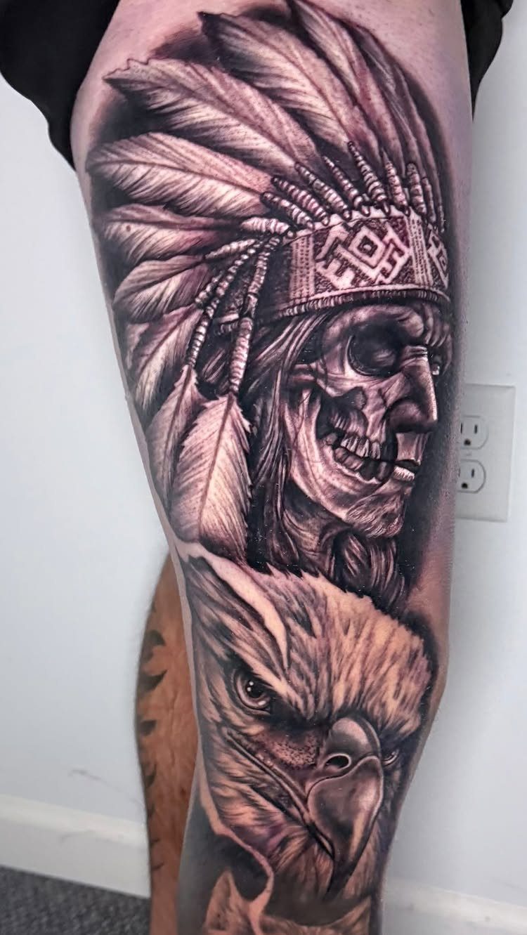 Leg Tattoo Base: 14 Placements from Ankle to Full Sleeve for 2026 11 A detailed black and grey realism tattoo of a Native American skull and an eagle on a leg.
